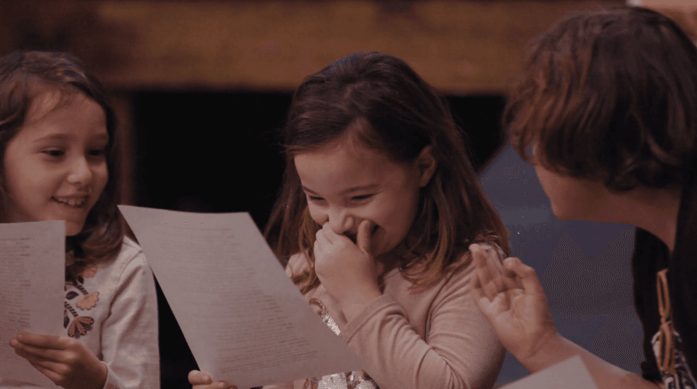 Children are shown rehearsing.
