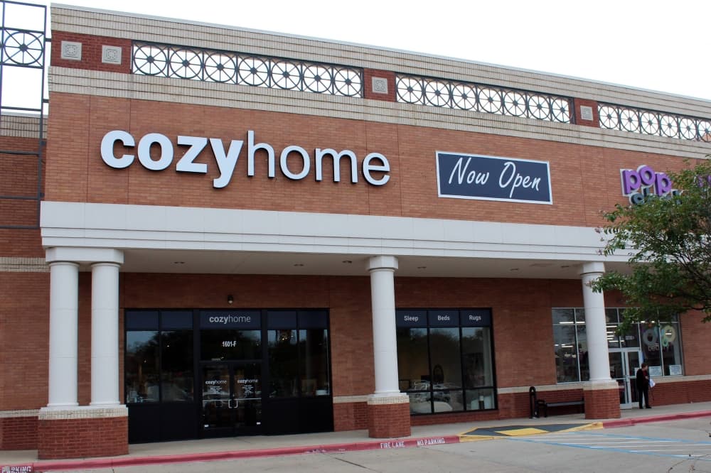 Exterior of building with Cozyhome signage and now open banner.