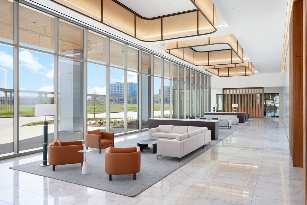 Interior of an office building with floor to ceiling windows. 