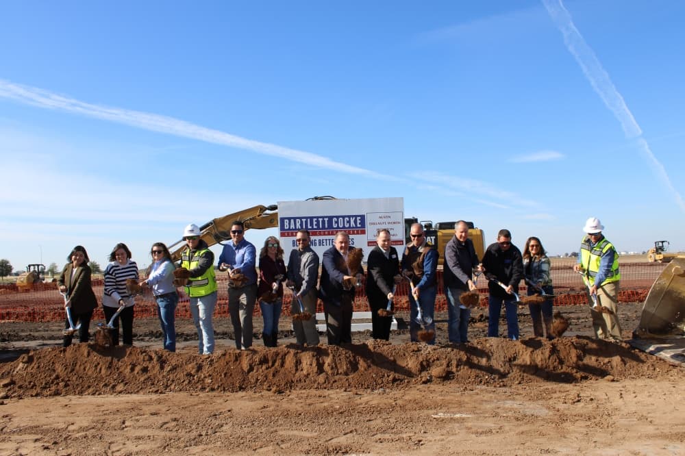 Officials hold shovels to pose for a groundbreaking photo. 