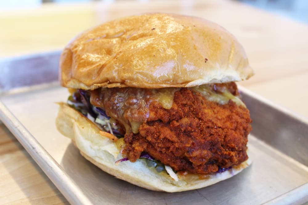 Chicken sandwich with honey drizzle.