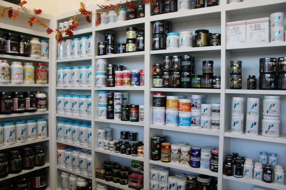 Protein powders and supplement on shelves. 