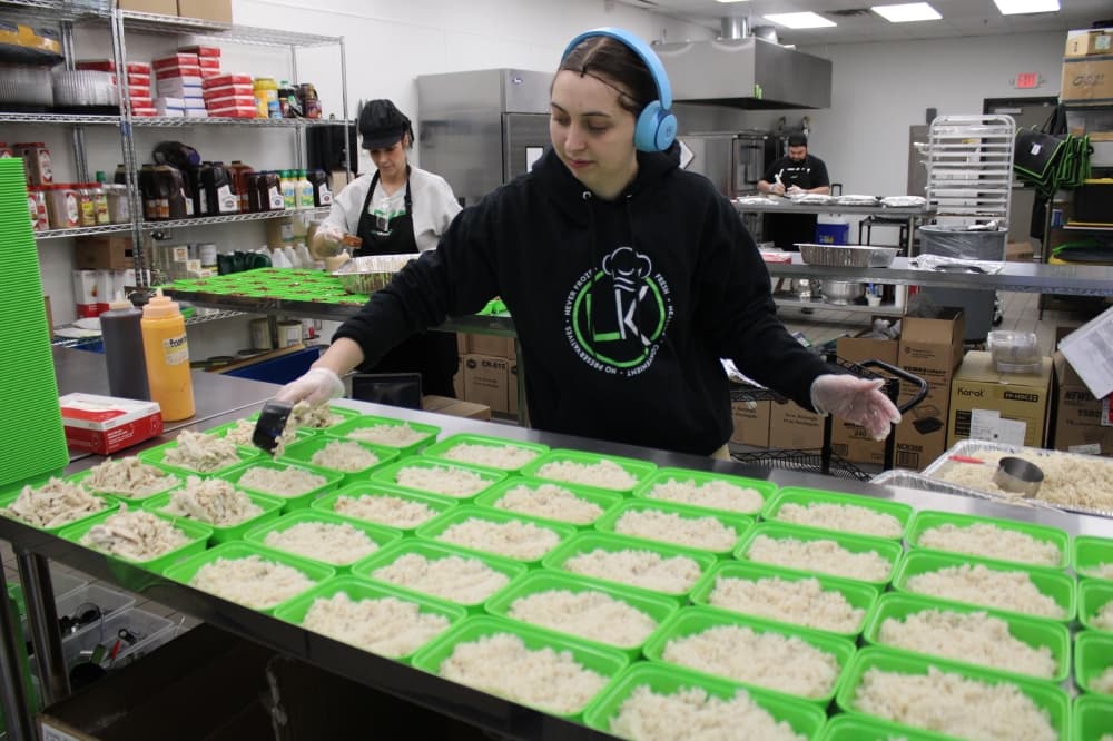 A woman does meal prep. 
