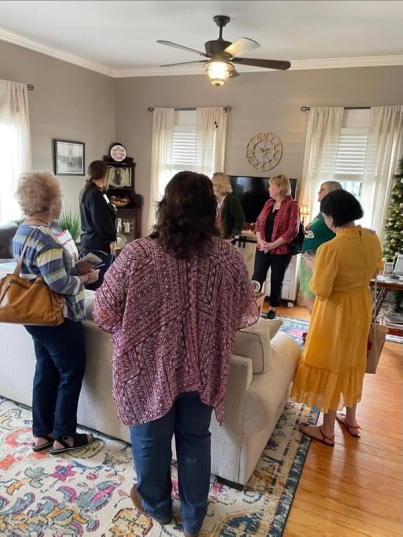 A group gathers inside a home during a previous tour.
