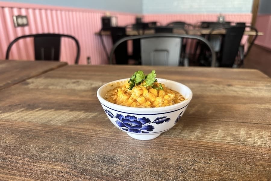 The creamed corn topped with curry powder adds a boost of flavor. (Thalia Guzman/Community Impact)