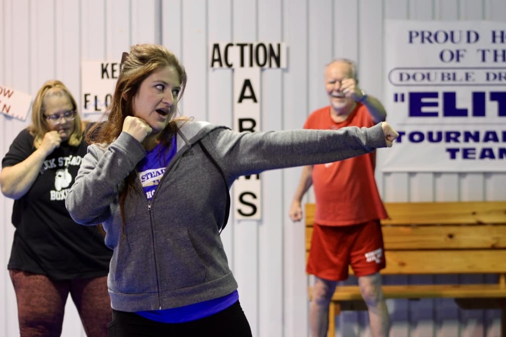 A Rock Steady boxing coach leads a punching drill during a class on December 2, 2024.