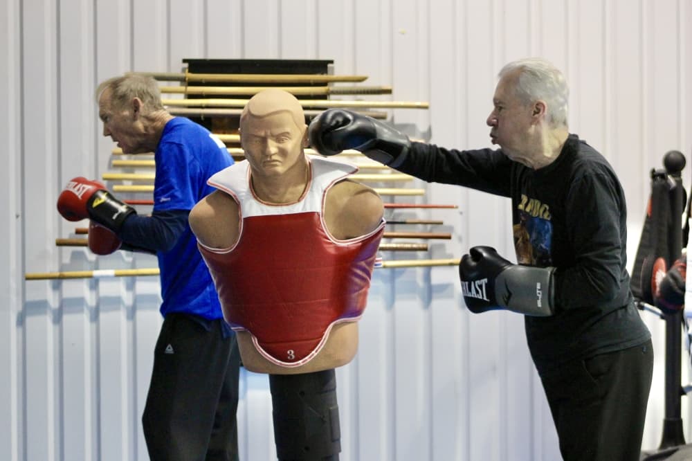 A Rock Steady boxer hits a punching dummy during a class on December 2, 2024.
