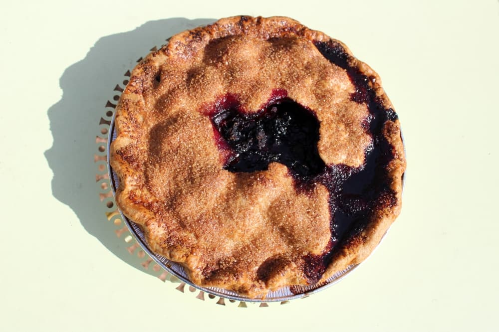 Large pie with shape of Texas cut out of the top crust with berry filling. 