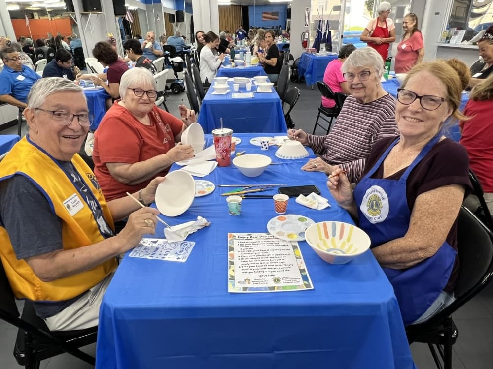 An image of people painting bowls. 