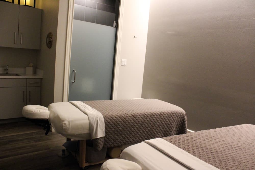 Two massage tables in a room. 