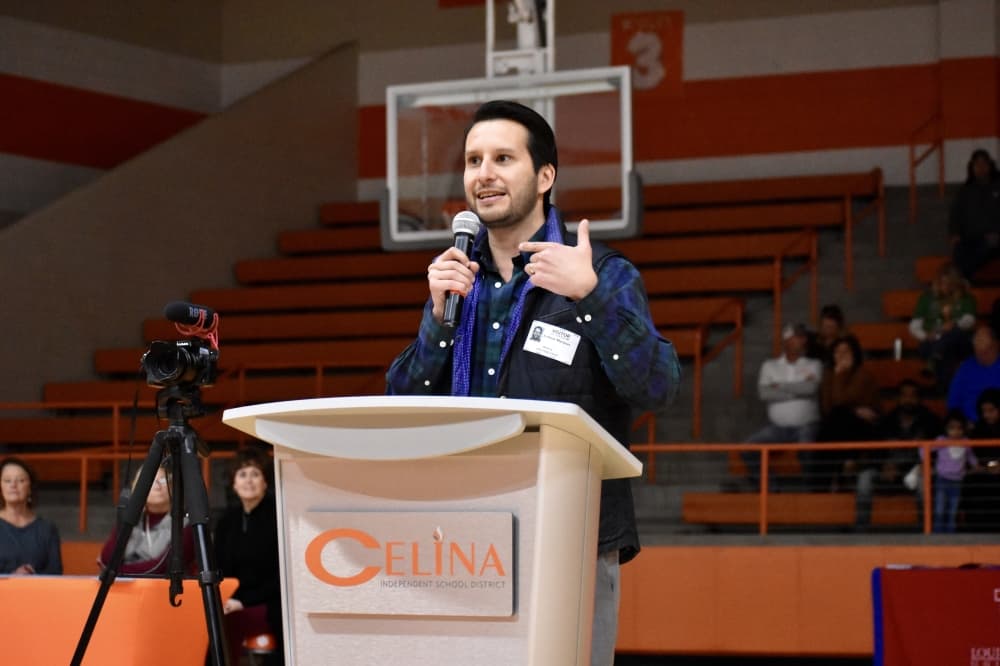 a man speaks behind a podium 