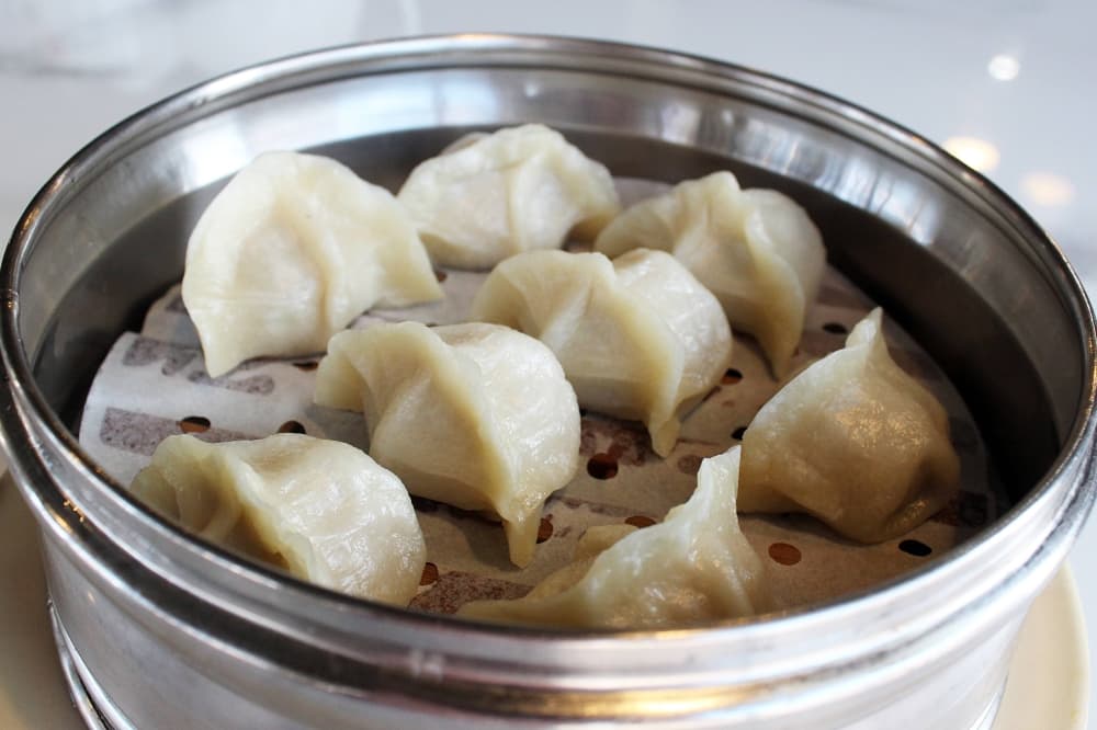 Steamed dumplings in a tin pan. 