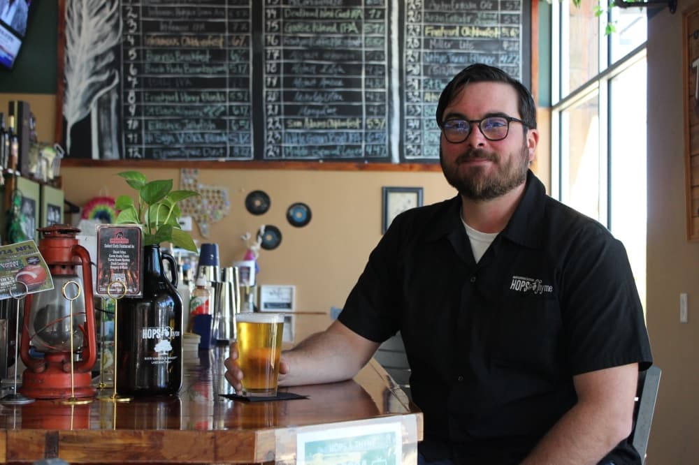 man sitting at bar with beer 