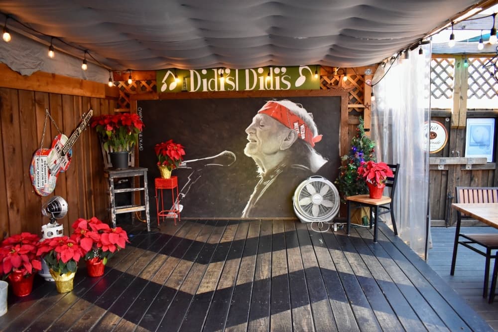Patio stage featuring mural of singer Willie Nelson. 