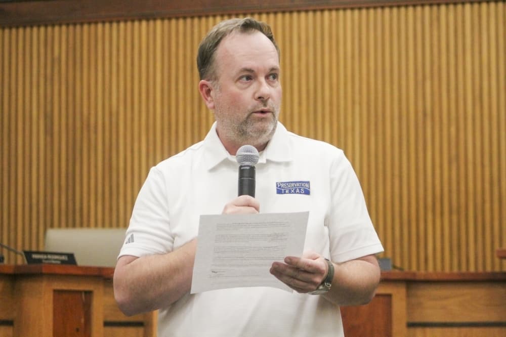 Preservation Texas Executive Director Evan Thompson read comments on behalf of Ryan Patrick Perkins. "These businesses embody the authenticity, resilience and community spirit that make our city unique," Thompson said. Preservation Texas is a local nonprofit organization that provides various statewide preservation programs. (Amira Van Leeuwen/Community Impact)