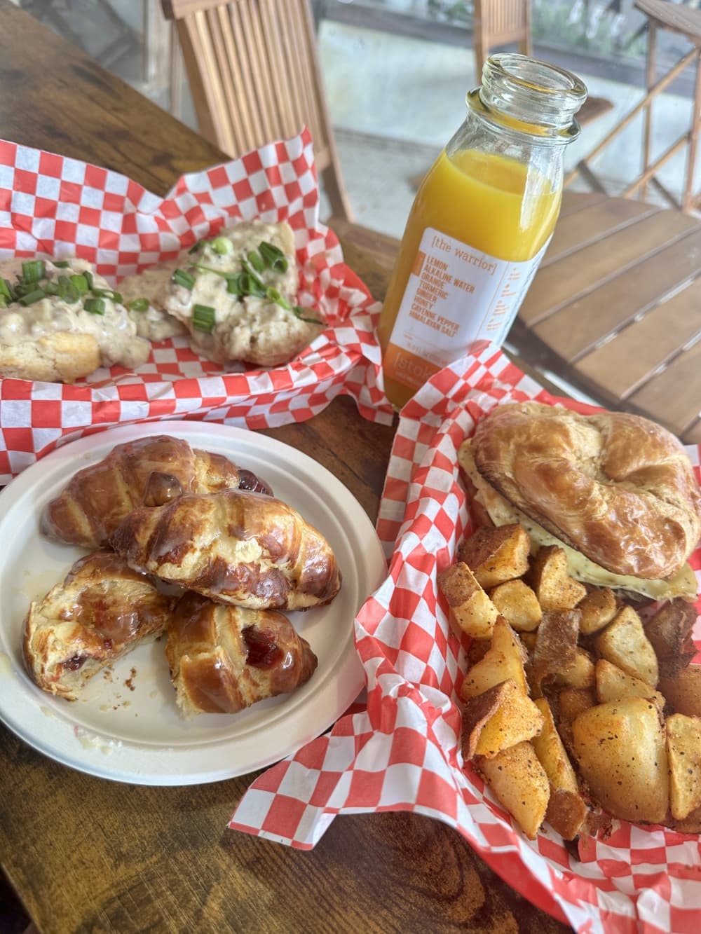 A table holds a range of food options and fresh juice.