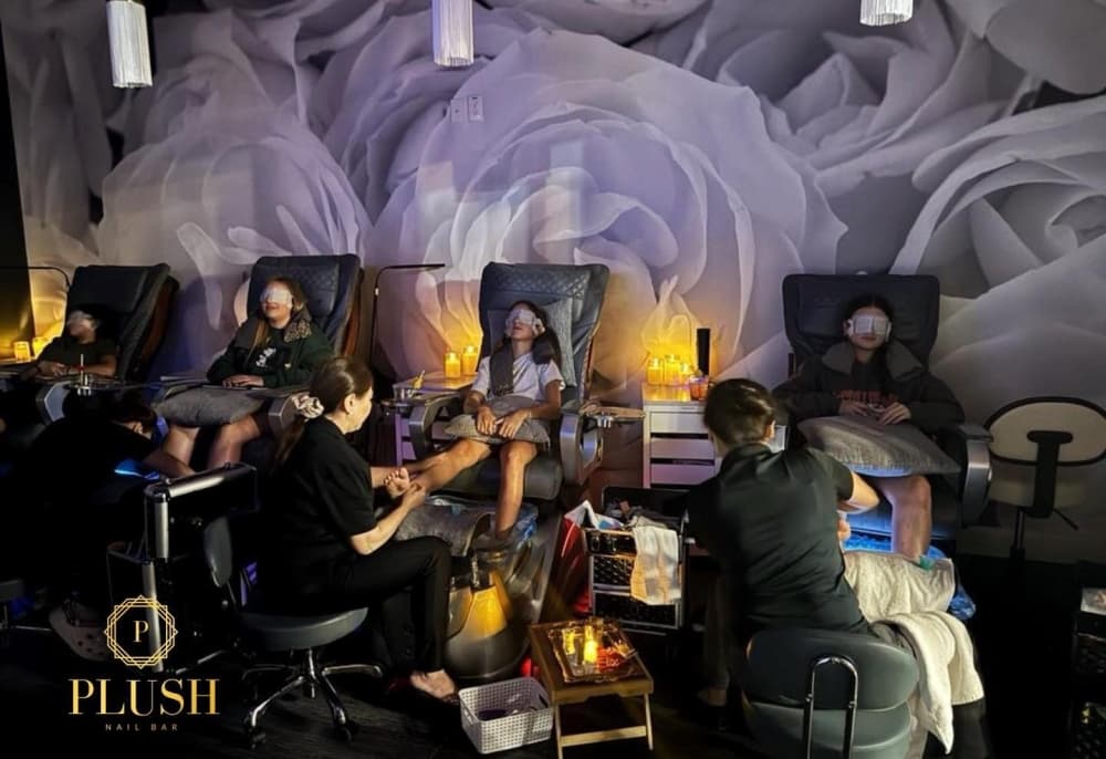 A row of women getting manicures.