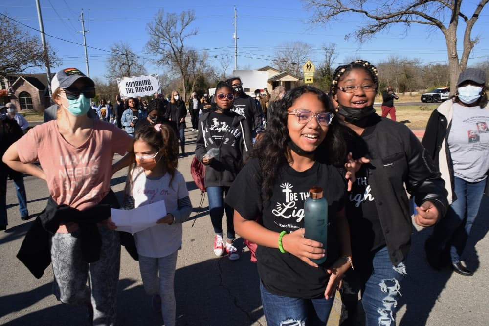 A group of adults and children walk at a previous event.