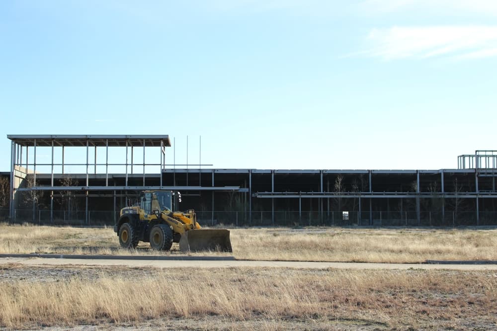 Scattered empty buildings and the infamous "hole on the tollway" are all that remain from Wade Park, a former mixed-use development at the same site as The Mix. (Alex Reece/Community Impact) 