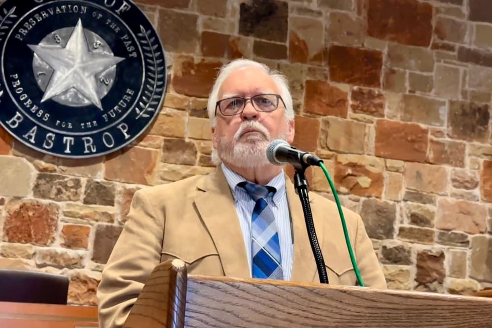 The Mayor is shown at the podium in front of a City of Bastrop emblem.