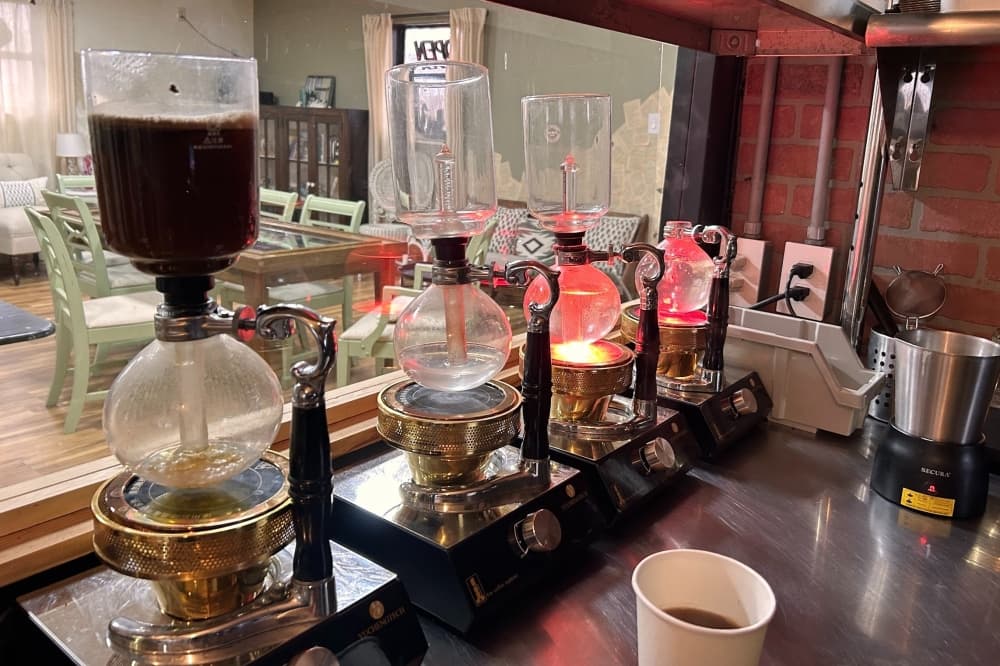 Siphon-brewed coffee is made with a special coffee maker that uses boiling water and vacuum pressure to brew. (Shaheryar Khan/Community Impact)