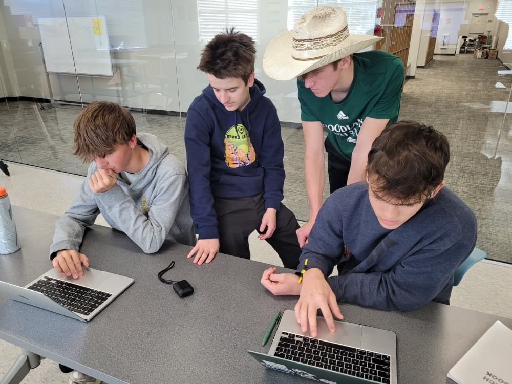 high school boys learning coding 
