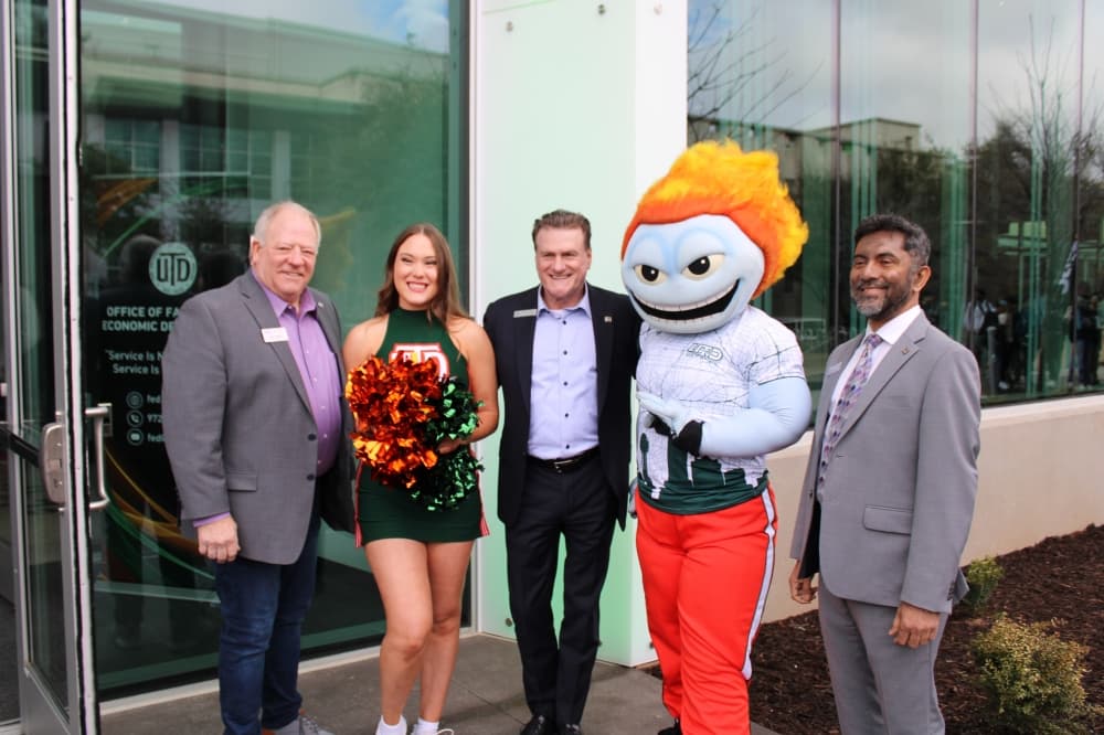 People posing at a ribbon cutting