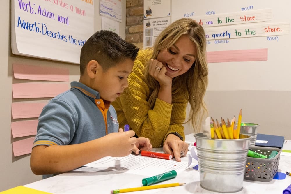 A teacher helping a student with homework.
