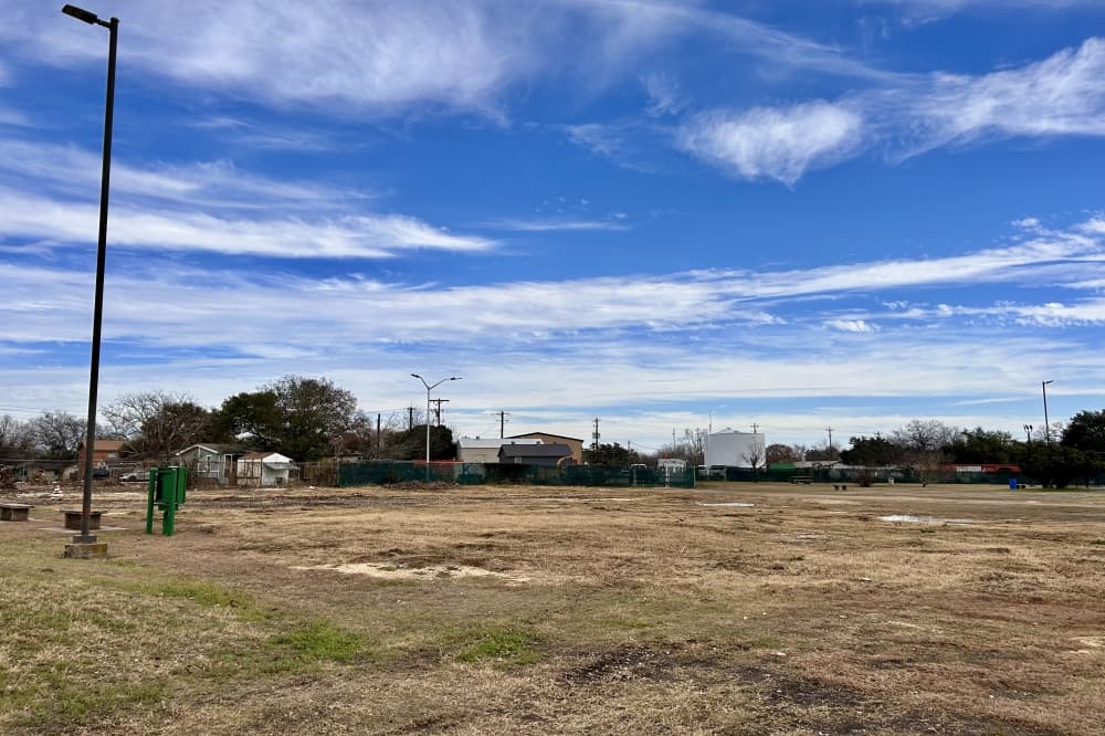 A photo of a large land full of grass and debris