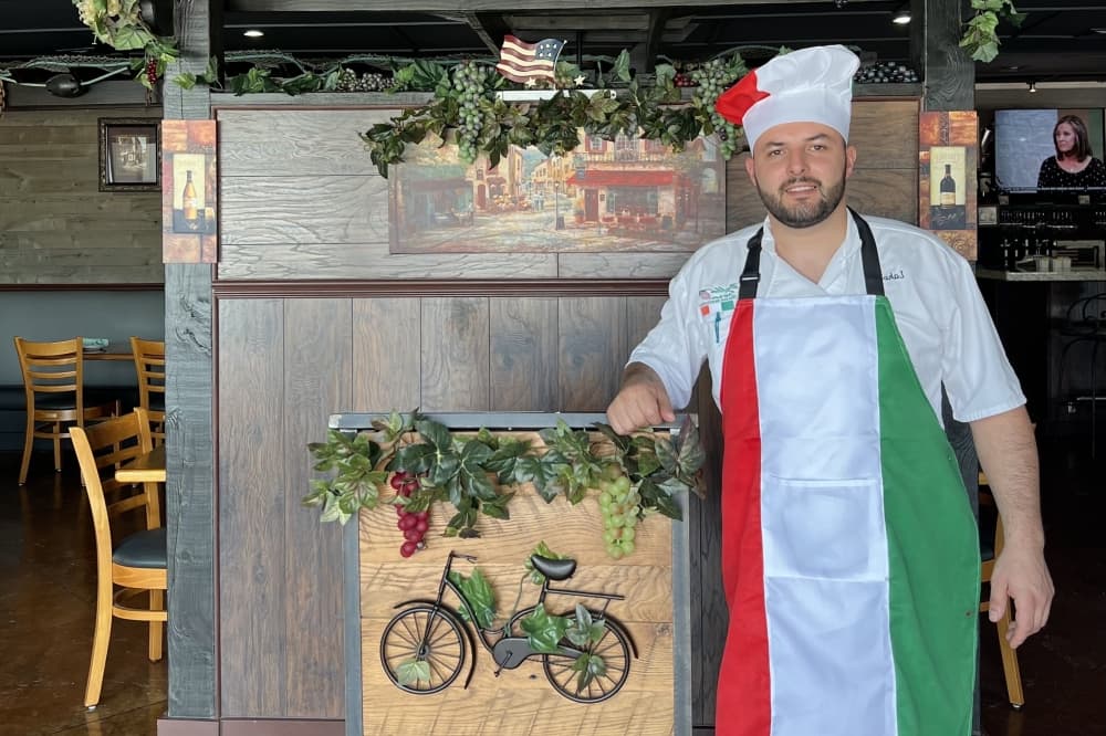 A man poses in a restaurant