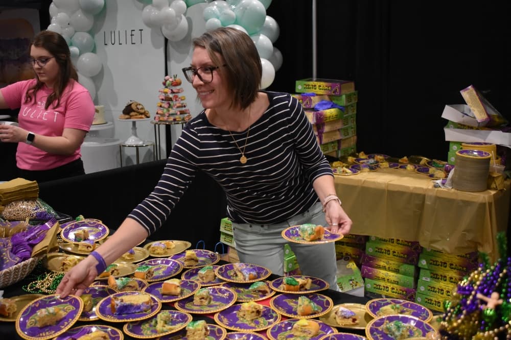 woman hands out cake samples