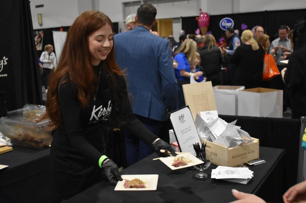 A young woman hands out food samples