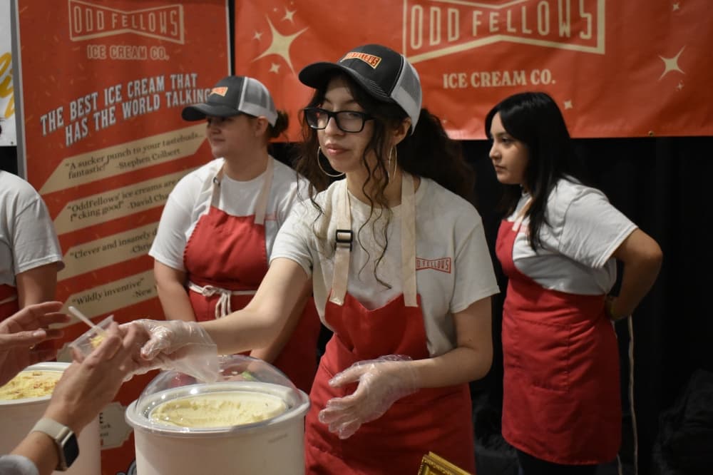 Young woman hands out ice cream samples