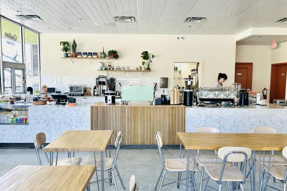 Interior photo of the coffee shop with multiple tables and a counter