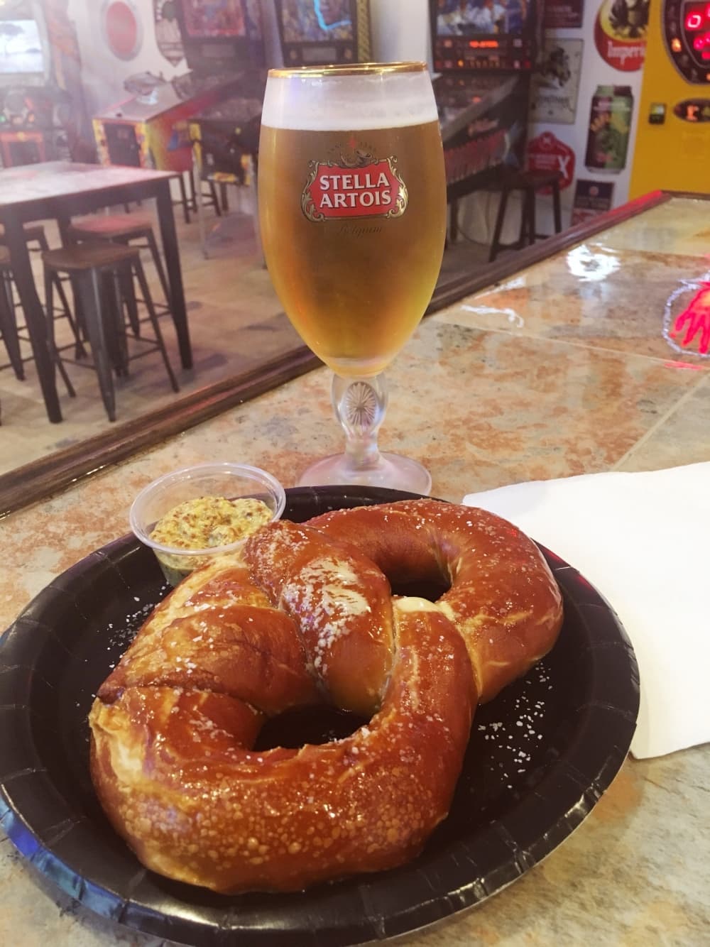 An image of the pretzel and a drink served. 