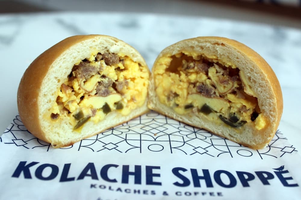 Side view of kolache with sausage, egg and cheese. 
