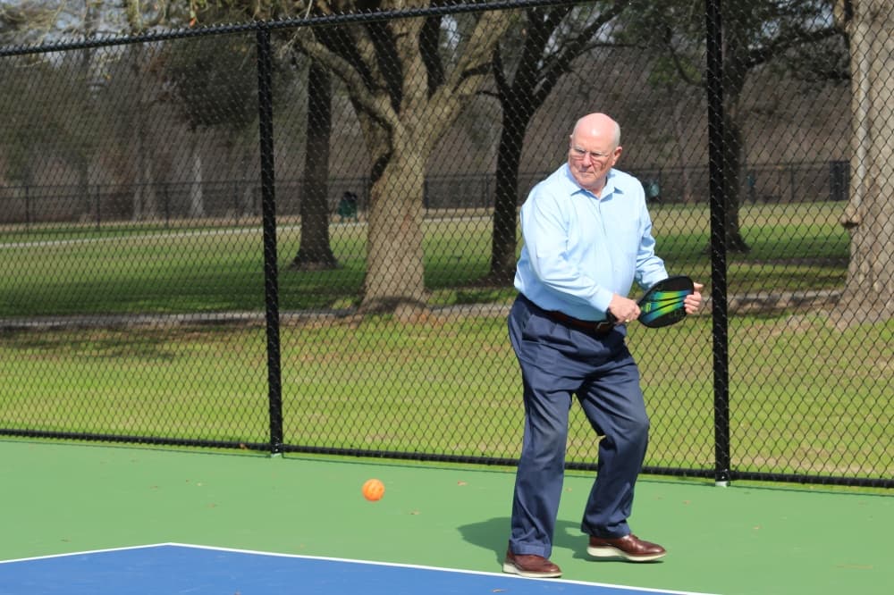 commissioner playing pickleball