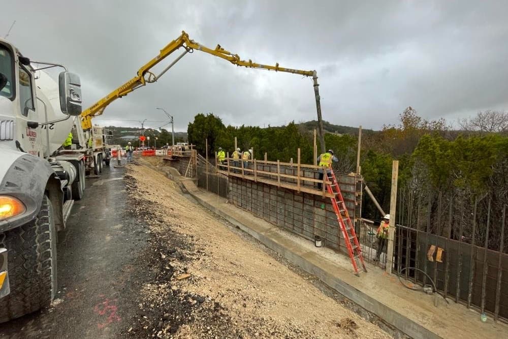 Construction crews installing a retaining wall as part of the Spicewood Springs Road Mobility Improvements project 