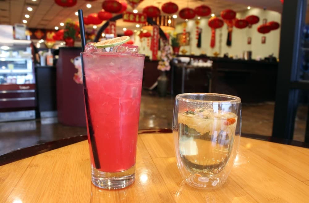 Two drinks on a table with Chinese lanterns in the background. 
