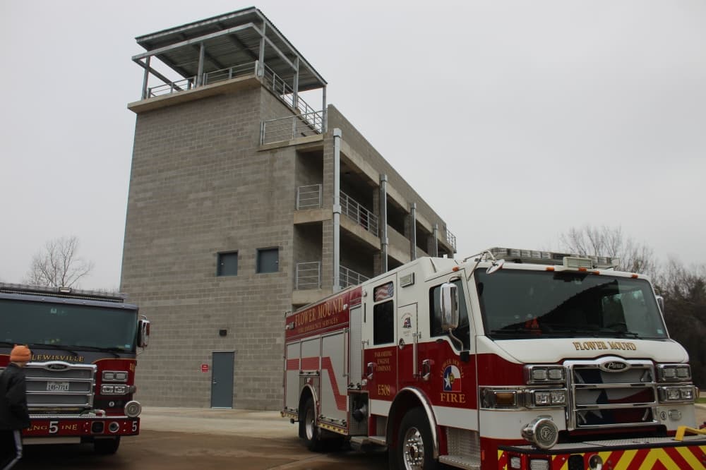 Image of the new 3.5-story training tower pictured behind a Flower Mound Fire Department truck.
