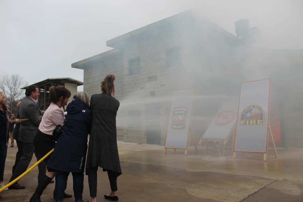Officials from Flower Mound, Highland Village and Flower Mound spray water into the 2-story training building.