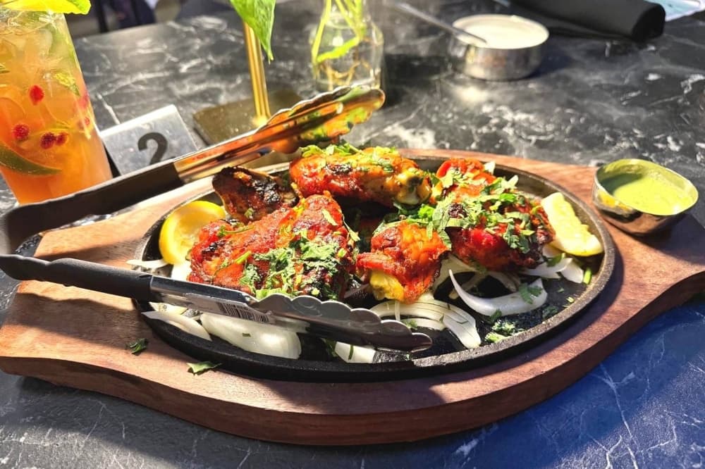 Food on a iron dish on a table. 
