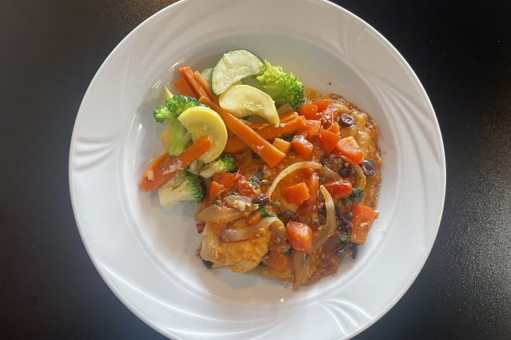 The tilapia livornese ($19.99) includes sauteed onions, olives and capers in a light tomato basil sauce, and is served with linguine. (Claire Shoop/Community Impact)