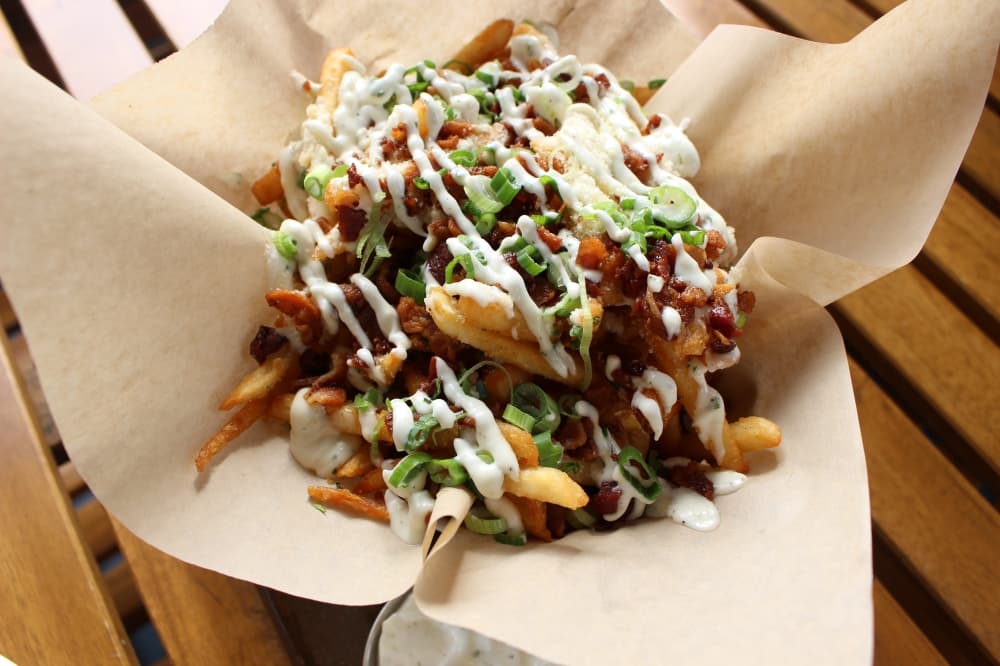 The garlic parmesan fries with bacon ($12) is one of the restaurant's best sellers, Montiel said. (Asia Armour/Community Impact)