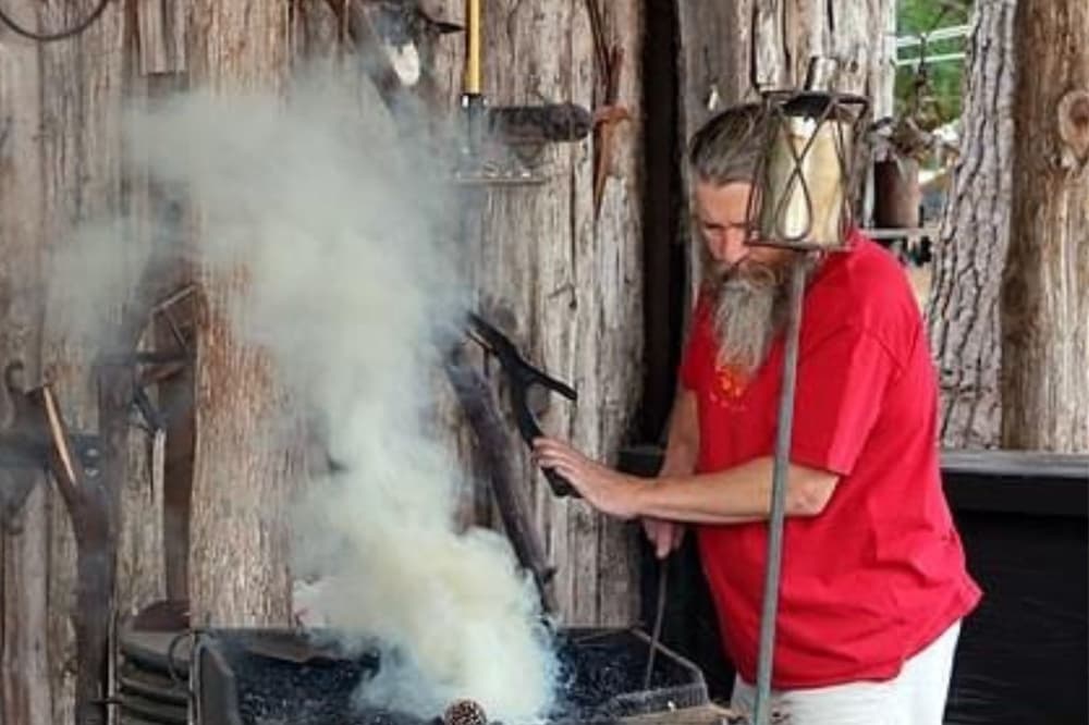 A blacksmith gives a demonstration on how he makes his wares.