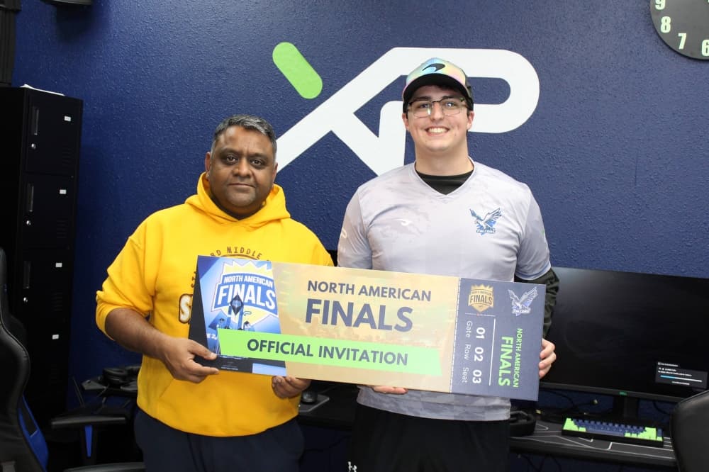 Two males holding a National Finals photo prop. 