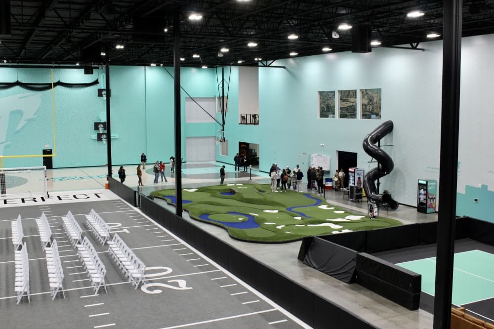 The main floor of Dude Perfect's new Frisco headquarters features a putting course and other amenities. (Alex Reece/Community Impact) 