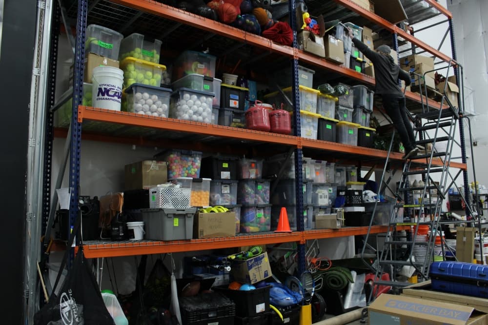 One wall of the Dude Perfect headquarter's art department and storage space. (Alex Reece/Community Impact)