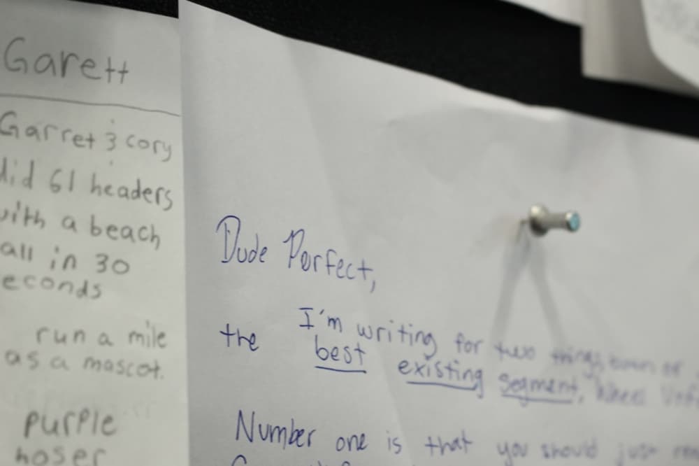 A bulletin board inside the Dude Perfect headquarters' employee work space features dozens of letters from fans to the group. (Alex Reece/Community Impact)