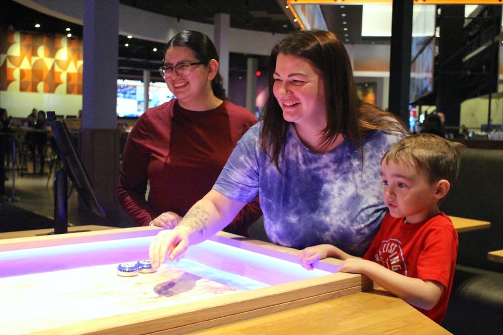 people play shuffleboard